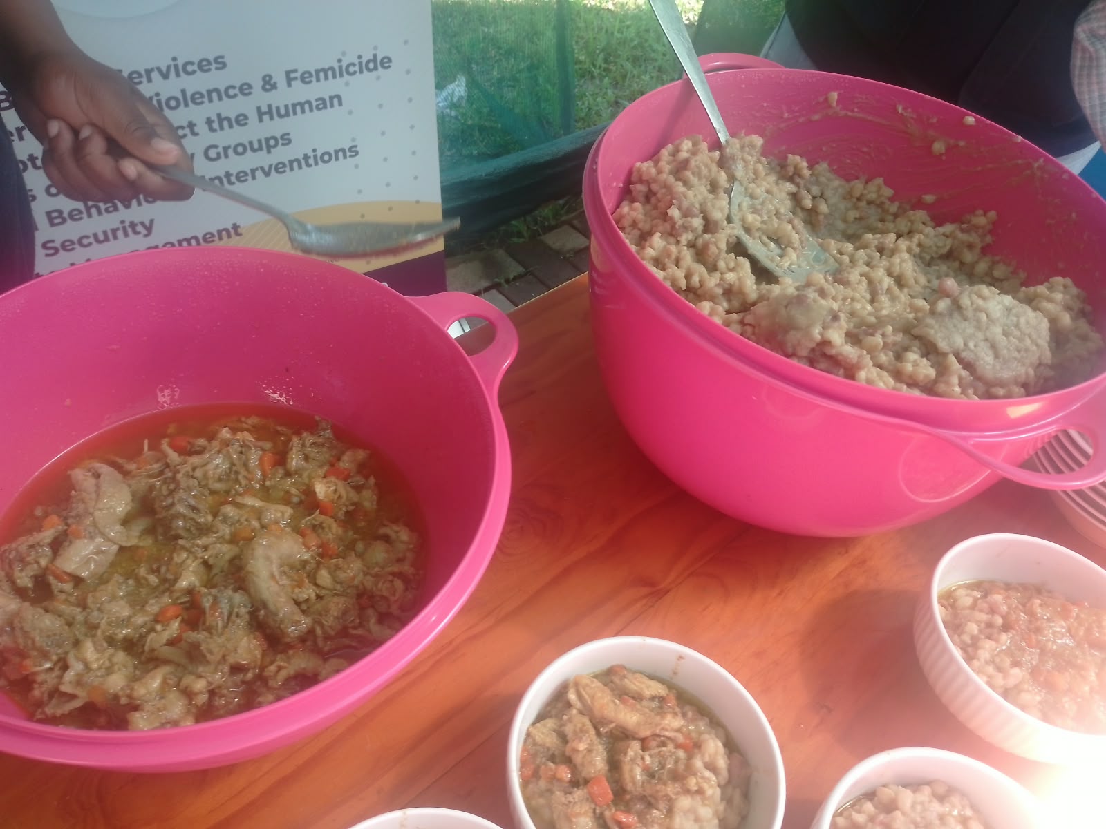 Large bowls of freshly prepared rice, stew and beans ready to be served